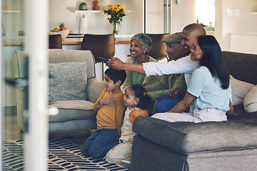 Image showing Family, kids and watching tv on sofa with grandparents, parents or remote control for choice in home. Men, women and children for television, movie or streaming video on lounge couch, smile and house