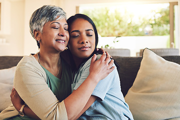 Image showing Family, senior woman hugging her daughter and love with people sitting on a sofa in the home living room during a visit. Smile, trust or comfort with an elderly female parent embracing an adult child