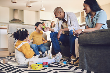 Image showing Family home, kids and parents with toys, living room and playful on floor with talking, laughing and games. Men, women and children with building blocks, development and learning in lounge in house