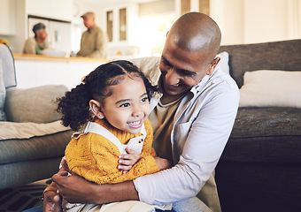 Image showing Happy family, smile and father with girl child on living room floor playing, laugh and bond in their home together. Love, hug and kid with parent in a lounge for tickle, fun and games on the weekend