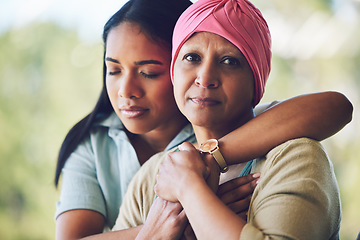 Image showing Love, hug and woman with her mother with cancer hugging, bonding and spending time together. Happy, sweet and portrait of a sick mature female person embracing her adult daughter in an outdoor garden