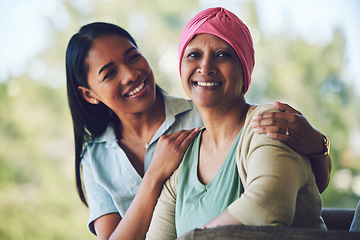 Image showing Happy, smile and woman with her mother with cancer sitting, bonding and spending time together. Sweet, love and portrait of sick mature female person embracing her adult daughter in an outdoor garden