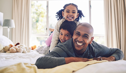 Image showing Bed, playful and portrait of a father with children for love, care or bonding in the morning. Happy, family and a young dad with kids in the bedroom of a house for quality time and playing together