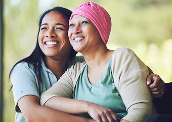 Image showing Love, bonding and woman with her mom with cancer hugging, sitting and spending time together. Happy, sweet and sick mature female person embracing her adult daughter with a smile in outdoor garden.