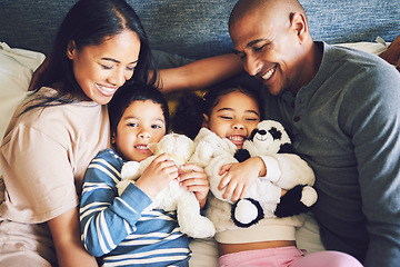 Image showing Parents, children and family in a bed together with love, care and security for comfort. Woman, man and kids with a teddy bear and happy smile for quality time in a home bedroom to relax from above