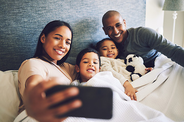 Image showing Parents, children or family selfie in a bed together with love, care and security or comfort. Woman, man and kids with a happy smile for quality time or profile picture in a home bedroom to relax