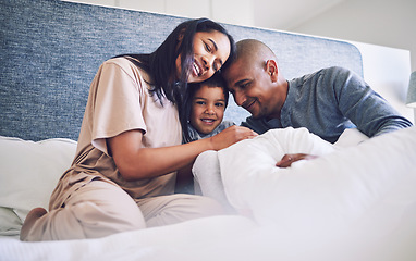 Image showing Family home, parents and child in a bed together with love, care and security for comfort. Latino woman, man and kid with a happy smile, commitment and quality time in bedroom in the morning to relax