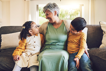 Image showing Laughing, grandmother or happy kids on a sofa with love enjoying quality bonding time together in family home. Smile, affection or funny senior grandparent hugging children siblings on house couch