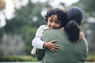 Image showing Love, care and portrait of child hug mother at outdoor park bonding for trust and happy for quality time together. Smile, mama and kid embrace parent or mom for happiness and support in mockup space