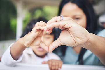 Image showing Mother, child and heart hands for love, care or compassion together in the outdoors. Mom and little kid putting hand for loving emoji, like or sign gesture for support, trust or parenting outside