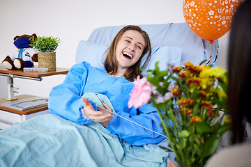 Image showing Sick, hospital patient and visitor with flowers at bed with a woman in recovery with support. Healthcare, medical insurance and person with good service, family and care with get well soon balloons