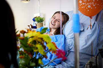 Image showing Hospital, sick patient and visitor with flowers at bed with a woman in recovery with support. Healthcare, medical insurance and person with bouquet, family and care with get well soon balloons