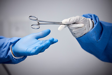 Image showing Surgery, hands or doctors with scissors with medicine or surgical procedure or healthcare in hospital. People, medical safety tools or closeup of surgeon in gloves helping in operating room in clinic