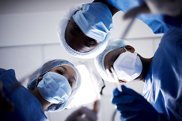 Image showing Surgery, low angle or doctors with face mask, scissors or surgical procedure or healthcare in hospital clinic. Teamwork, medical safety tools or surgeons working in gloves helping in operating room