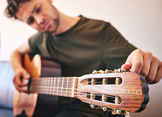 Image showing Closeup, man and tuning guitar for music, talent and creative skill of sound production in home studio. Hands, musician and singer check notes of acoustic instrument for audio, performance and artist