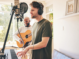 Image showing Microphone, guitar and friends singing with piano in home studio together. Electric keyboard, acoustic instrument and recording band, creative music production and men live streaming on headphones.