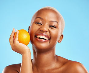 Image showing Orange, portrait and black woman with skincare, natural beauty and dermatology on a blue studio background. Female person, face detox or model with citrus fruit, cosmetics and wellness with vitamin c