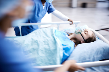 Image showing Hospital, bed and patient with surgeon running in surgery, emergency and support for healthcare service. Theatre, doctors and sick child with medical people or nurses in speed for crisis and problem