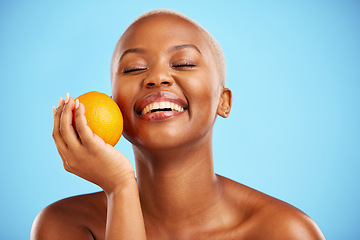 Image showing Orange, funny and black woman with skincare, dermatology or cosmetics on a blue studio background. Female person, humor or model with citrus fruit, health or wellness with vitamin c or natural beauty