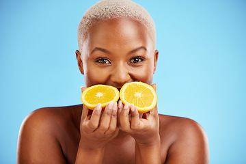 Image showing Portrait, beauty and fruit with a model black woman in studio on a blue background for natural wellness. Face, skincare and orange with a happy young female person holding a fresh snack for health