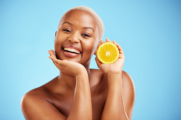 Image showing Portrait, beauty and orange with a black woman in studio on a blue background for fruit nutrition. Smile, skincare or diet with a happy young female person holding food for natural health or wellness