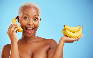Image showing Happy black woman, banana and diet for potassium, vitamin or fiber against a blue studio background. Portrait of African female person with bunch of yellow fruit for health and wellness on mockup