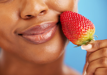 Image showing Strawberry, lips and beauty woman for cosmetics, eco friendly product and color choice. Happy, mouth and skincare person or model, red fruit and dermatology or vegan makeup on studio blue background