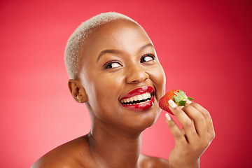 Image showing Beauty, thinking face and a woman with a strawberry on a red background for health and wellness. Black female aesthetic model with a smile, makeup and fruit for nutrition and healthy diet in studio