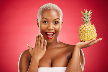 Image showing Beauty, portrait and pineapple surprise with a woman in studio for healthy food, diet or fruit. Black person with makeup on red background for face wellness, natural cosmetics and wow skin care glow