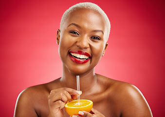 Image showing Happy black woman, portrait and orange for vitamin C, diet or natural nutrition against a red studio background. African female person smile and drinking organic citrus fruit with straw on mockup