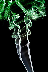 Image showing Abstract green smoke. Isolated on a black background