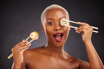 Image showing Sushi, portrait and woman with chopsticks in studio for healthy eating, beauty and food. Face of excited black person with makeup on a dark background for wellness, diet or wow seafood advertising