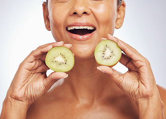 Image showing Excited, face and senior woman with kiwi in studio isolated on a white background. Food, fruit and natural model with nutrition for skincare, diet and vitamin c for anti aging, cosmetics or health