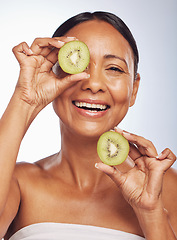 Image showing Face, skincare and senior woman with kiwi in studio isolated on a white background. Food, natural fruit and portrait of happy model with nutrition for wellness, healthy diet and anti aging for beauty