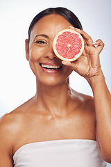 Image showing Skincare, face and mature woman with grapefruit in studio isolated on a white background. Portrait, natural fruit and happy model with food for nutrition, wellness and healthy diet for anti aging.