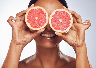 Image showing Smile, face and senior woman with grapefruit in studio isolated on a white background. Skincare, natural fruit and happy model with food for nutrition, healthy diet and vitamin c for anti aging.