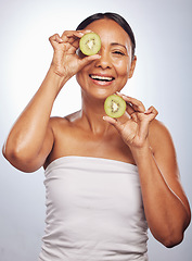 Image showing Skincare, portrait and senior woman with kiwi in studio isolated on a white background. Food, natural fruit and face of happy model with nutrition for wellness, healthy diet and anti aging for beauty