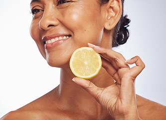 Image showing Thinking, orange and senior woman with skincare, cosmetics and vitamin c against a white studio background. Mature female person, happy lady or model with citrus fruit, natural beauty and nutrition