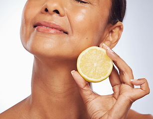 Image showing Cosmetics, orange and senior woman with skincare, natural beauty and vitamin c on a white studio background. Mature female person, self care and model with citrus fruit, natural beauty and wellness