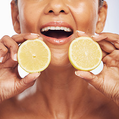 Image showing Closeup, orange and senior woman with skincare, cosmetics and dermatology on a studio background. Zoom, female person or model with citrus fruit, treatment and natural beauty with vitamin c or health