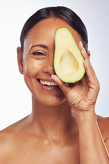 Image showing Face, skincare and senior woman with avocado in studio isolated on a white background. Happy, natural fruit or portrait of mature model with food for nutrition, healthy diet or omega 3 for anti aging