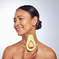 Image showing Skincare, thinking and senior woman with avocado in studio isolated on a white background. Happy, natural fruit and mature model holding food for nutrition, healthy diet or omega 3 for anti aging.