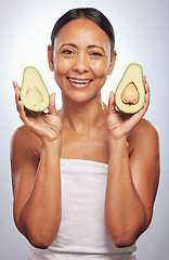 Image showing Portrait, skincare and senior woman with avocado in studio isolated on a white background. Face, natural fruit and happy model with food for vegan nutrition, healthy diet and omega 3 for anti aging.