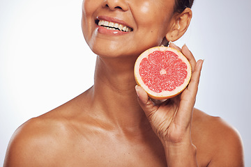 Image showing Skincare, beauty and happy woman with grapefruit in studio isolated on a white background. Food, natural fruit and hand of model with nutrition for wellness, healthy diet and vitamin c for anti aging