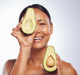 Image showing Senior, anti aging and portrait of woman with avocado for skincare, nutrition or diet. Happy, face and elderly model or lady with food for wellness, beauty and detox isolated on a studio background