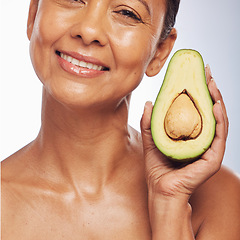Image showing Skincare, face and mature woman with avocado in studio isolated on a white background. Portrait, natural fruit and happy model with food for organic nutrition, healthy diet and omega 3 for anti aging