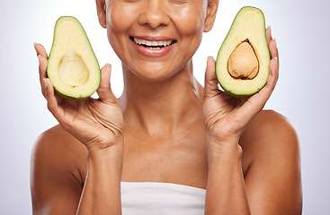 Image showing Avocado, skincare or happy woman with fruit for a healthy diet, detox or vitamins with beauty in studio. Wellness, hands closeup or face of model smiling in dermatology treatment on white background