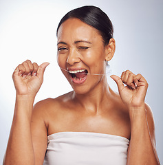 Image showing Dental, portrait or mature woman flossing teeth for beauty or wellness in studio on white background. Smile, self care or healthy senior model grooming or cleaning her tooth or mouth for hygiene