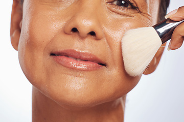 Image showing Brush, portrait or senior woman in studio for cosmetics powder, beauty or facial grooming treatment. White background, senior or face of mature model applying foundation product in self care routine