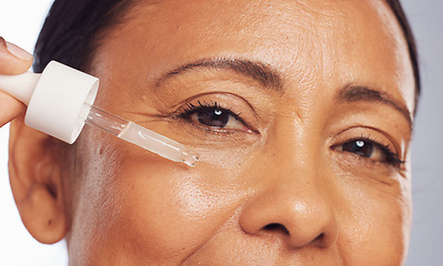 Image showing Woman, serum and portrait of face with dropper for beauty, aesthetic skincare or dermatology in studio. Closeup of mature female model, facial cosmetic oil and hyaluronic acid for collagen cosmetics